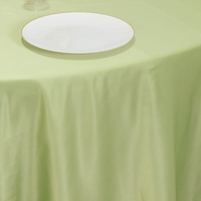 Green tablecloth with a white plate on it.