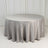 Round table covered with a smooth, silver tablecloth.