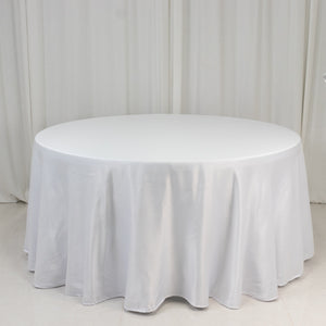 Round white table with a draped tablecloth