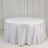 Round white table with a draped tablecloth