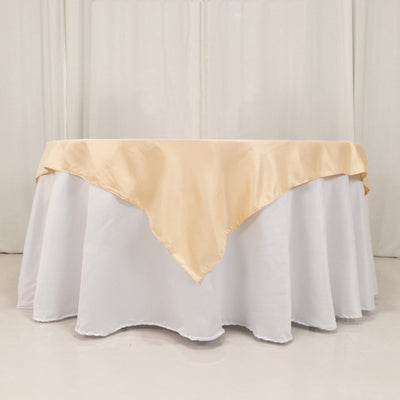 Cream satin tablecloth draped elegantly over a round white table.