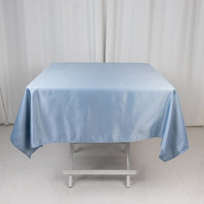 Blue satin tablecloth draped over a white table.