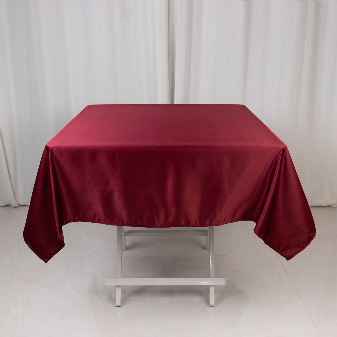 Red satin tablecloth on a plain white backdrop