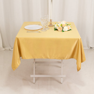 Elegant yellow tablecloth draped over a table with decor.