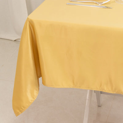 Yellow satin tablecloth draped elegantly over a dining table.