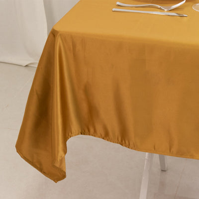 Gold satin tablecloth draped elegantly over a table.