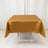 Gold satin tablecloth draped over a white folding table