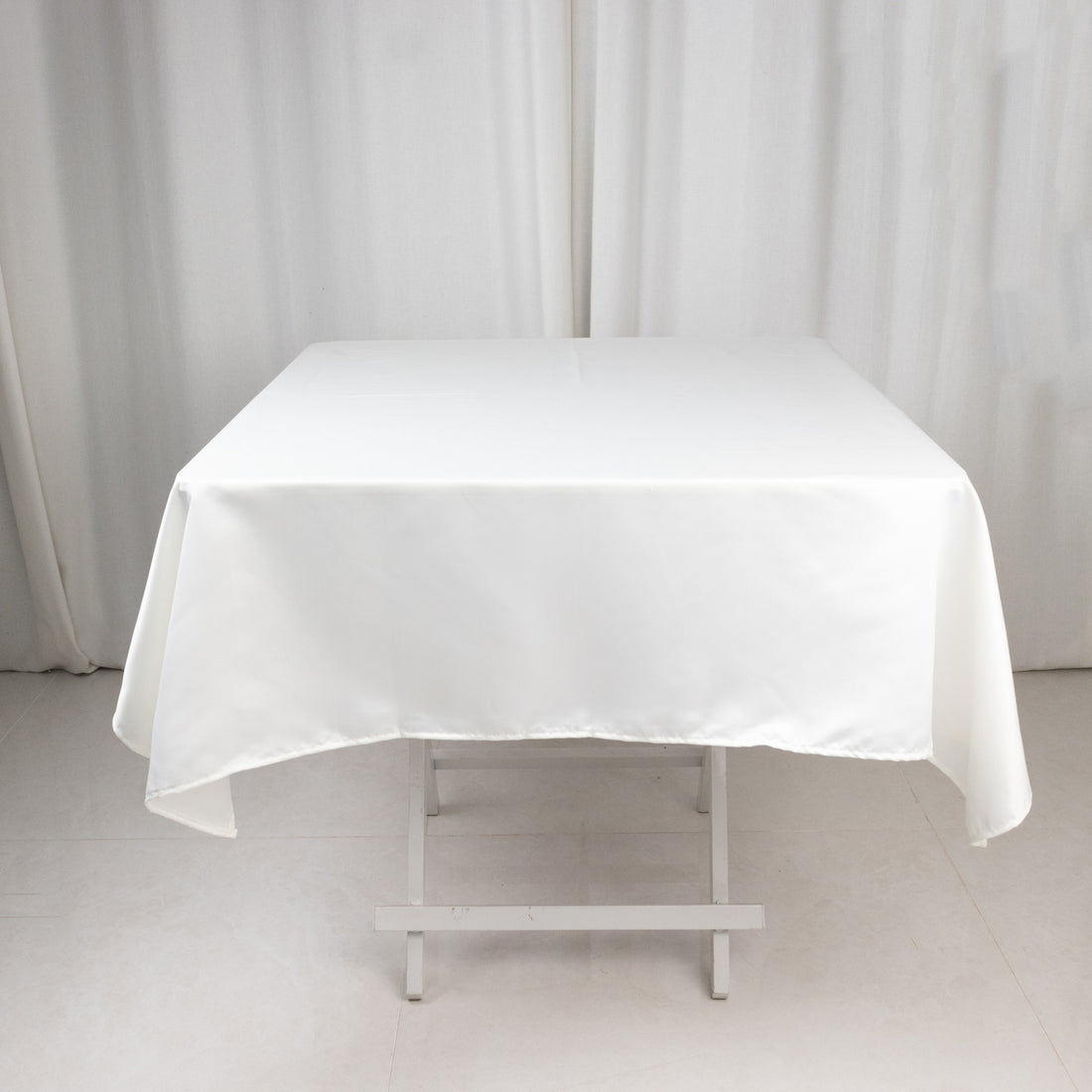 White tablecloth draped over a table in a studio setting