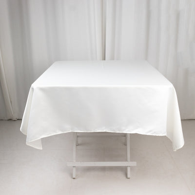 White tablecloth draped over a table in a studio setting