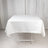 White tablecloth draped over a table in a studio setting