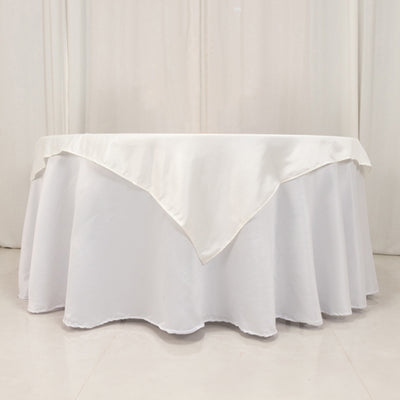 White tablecloth with elegant draping and pointed edge.