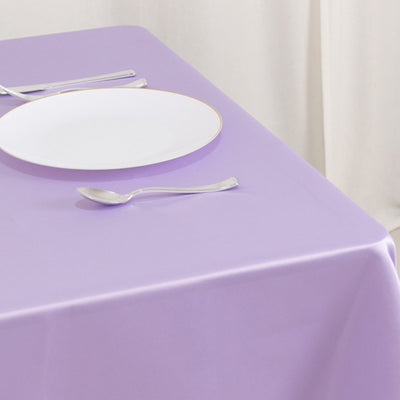 Purple tablecloth with a white plate and cutlery.