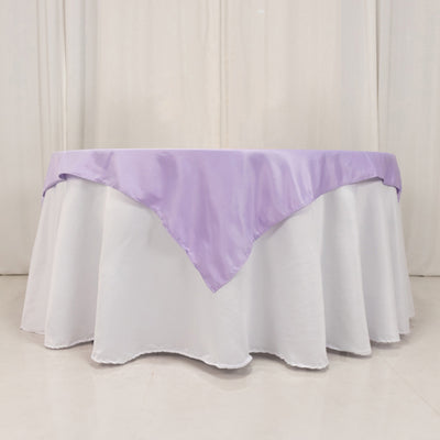 Lavender tablecloth draped over a round white table