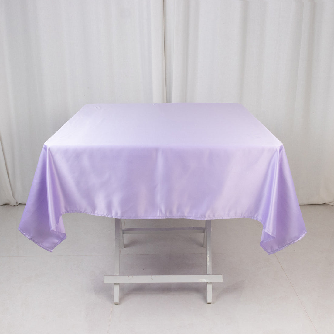 Lavender satin tablecloth draped over a folding table