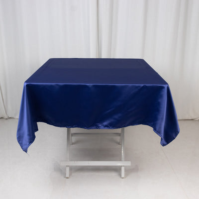 Navy blue satin tablecloth draped over a folding table