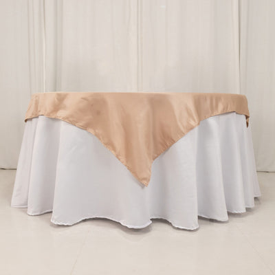 Elegant table with a beige satin overlay on a white tablecloth