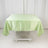 Green satin tablecloth draped over a folding table