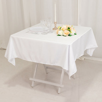 White table setting with floral centerpiece and glassware.