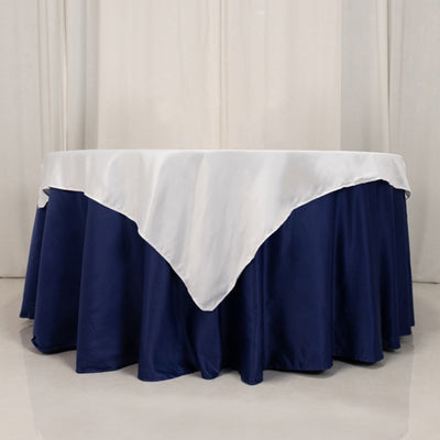 Navy blue tablecloth with white overlay on round table