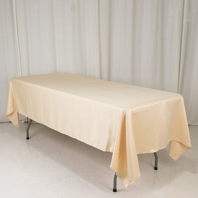 Beige tablecloth draped over a rectangular table in a studio setting.