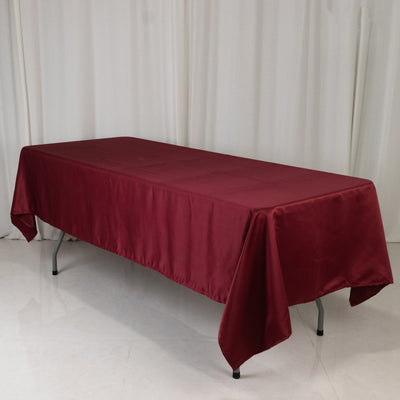 Burgundy tablecloth draped over a long table in a studio setting