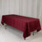Burgundy tablecloth draped over a long table in a studio setting