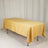 Yellow tablecloth draped over a folding table in a studio setting.