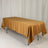 Golden tablecloth draped over a table in a studio setting.