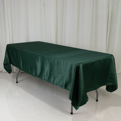 Green satin tablecloth draped over a rectangular table