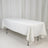 White tablecloth draped over a rectangular table in a studio setting.