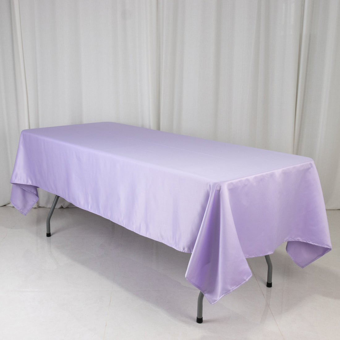 Purple tablecloth draped over a folding table on a white background.