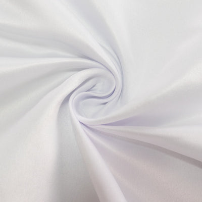 White fabric swirl texture close-up showcasing smooth, soft material.