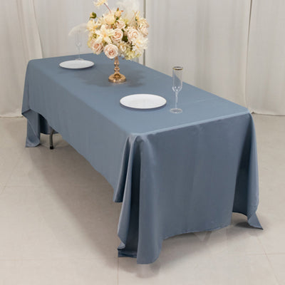 Elegant blue tablecloth draped over a banquet table with floral centerpiece.