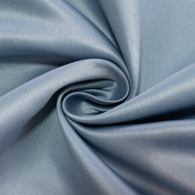Blue satin fabric with a smooth, shiny surface, arranged in a spiral pattern.