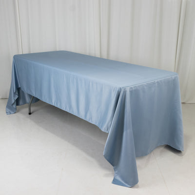 Blue tablecloth draped over a folding table in a studio setting.