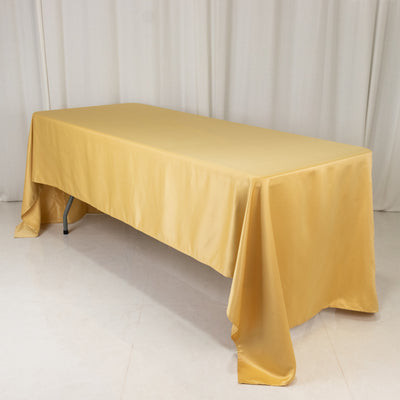 Yellow tablecloth draped over a rectangular table in a studio setting.