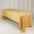 Yellow tablecloth draped over a rectangular table in a studio setting.
