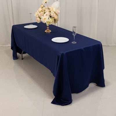 Navy blue tablecloth draped over a table set for an elegant dining experience.