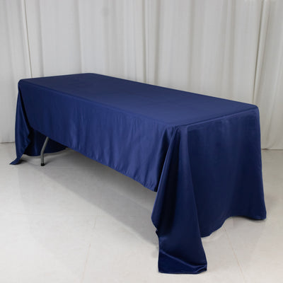 Navy blue tablecloth draped over a folding table in a studio setting.