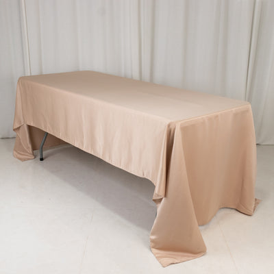 Beige tablecloth draped over a table in a studio setting.