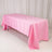 Pink tablecloth draped over a table in a studio setting.