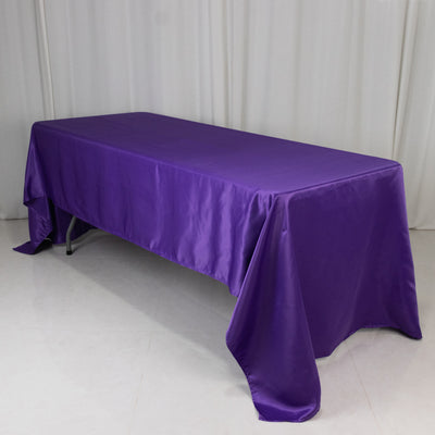 Purple tablecloth draped over a table in a studio setting.