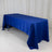 Blue tablecloth draped over a folding table on a white backdrop.