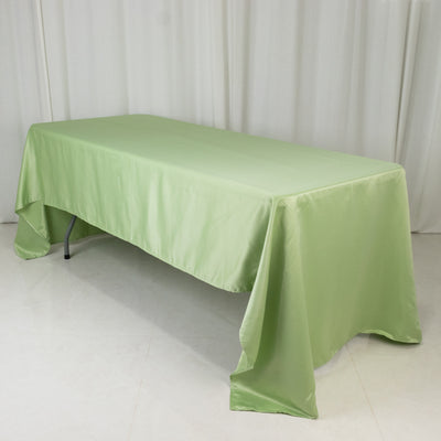 Green tablecloth draped over a table in a studio setting.