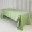 Green tablecloth draped over a table in a studio setting.