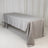 Gray tablecloth draped over a rectangular table