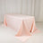 Pink tablecloth draped elegantly over a table in a studio setting.