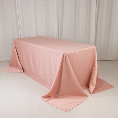 Pink tablecloth draped elegantly over a table in a studio setting.