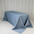 Blue tablecloth draped elegantly over a table against a plain backdrop.