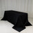 Black table draped with a smooth fabric cover in a minimalistic setting.